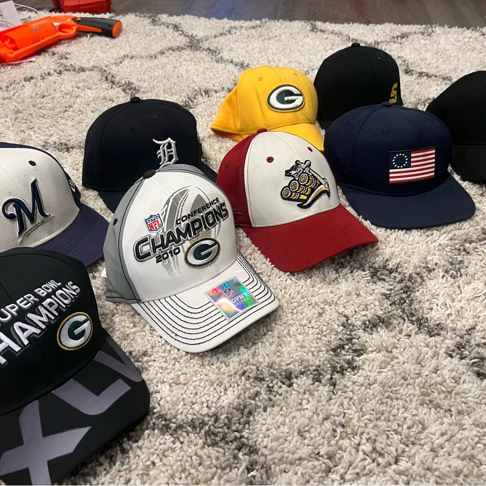 Green Bay Packers Super Bowl Champions Caps with several others mixed in